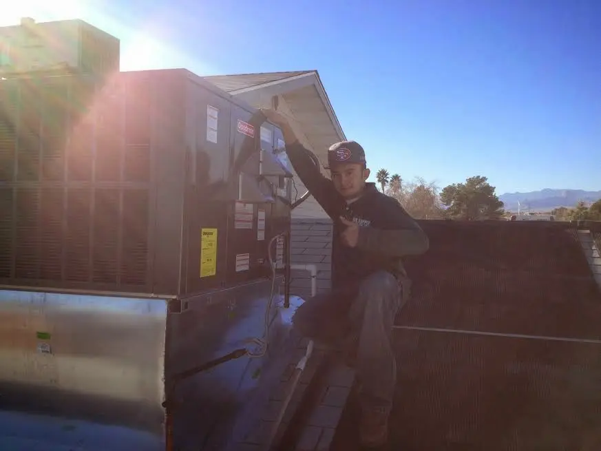 HVAC technician performing HVAC Inspection on a rooftop unit in Minden